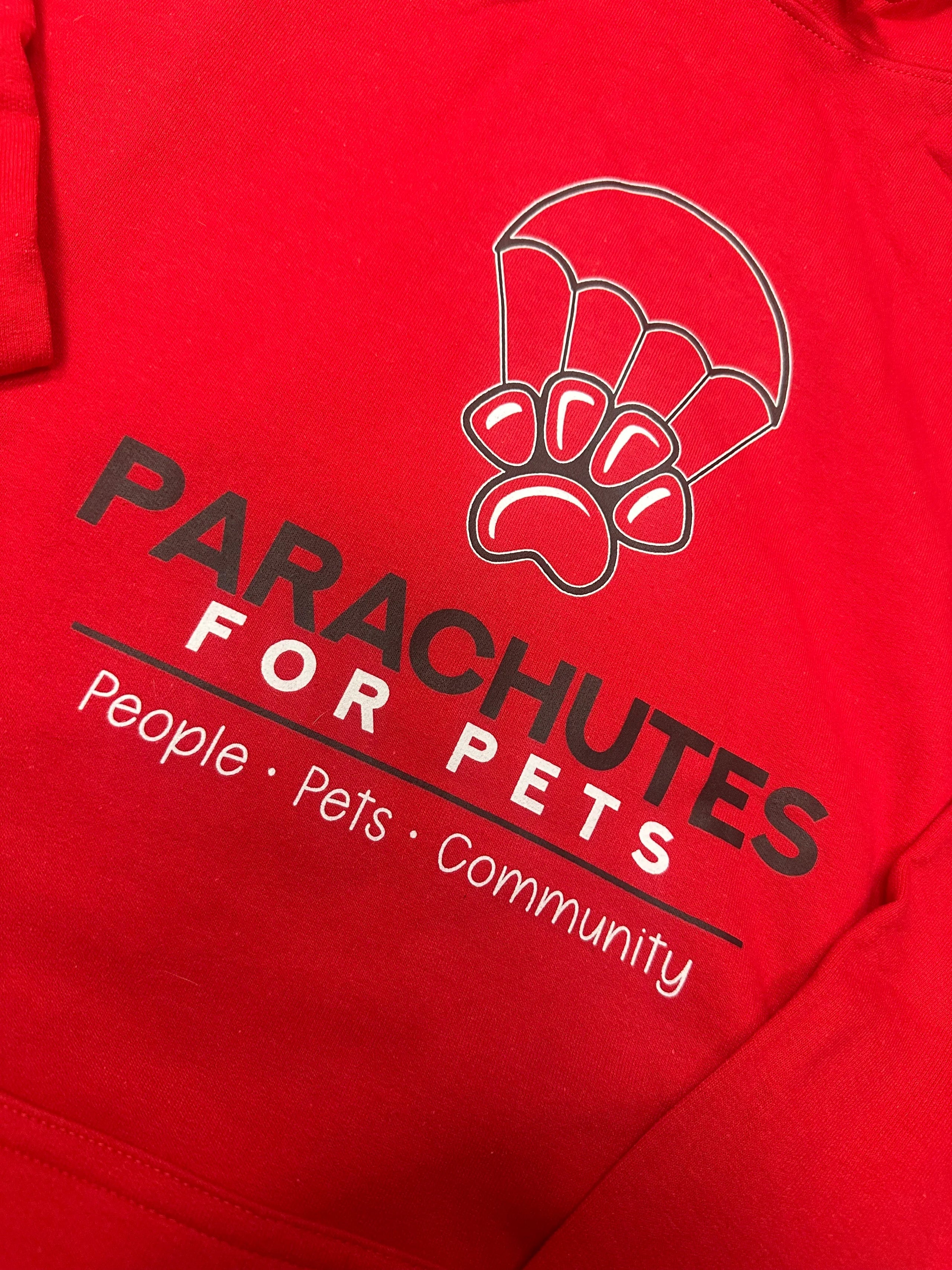 Red sweatshirt with 'Parachutes for Pets' logo and text on a red background