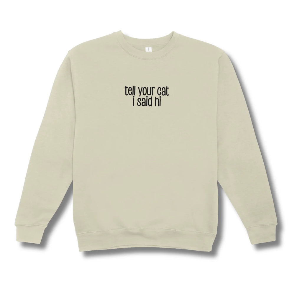 Beige sweatshirt with text 'tell your cat I said hi' on a white background